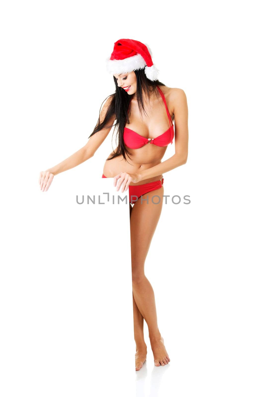 Sexy santa girl holding blank board, isolated on white