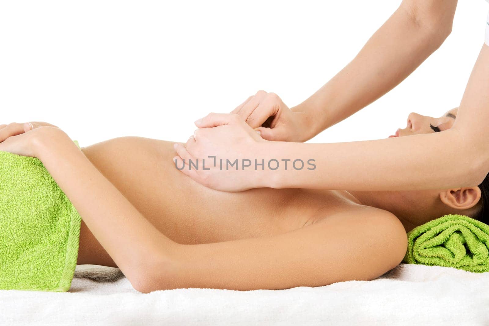 Beauty young woman relaxing in spa. Breast massage.