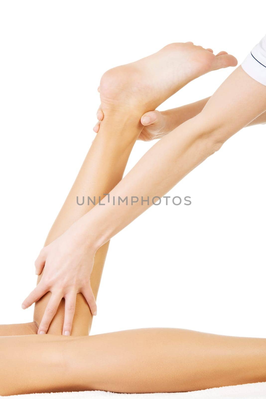 Physio therapist trying to fix the legs over white background