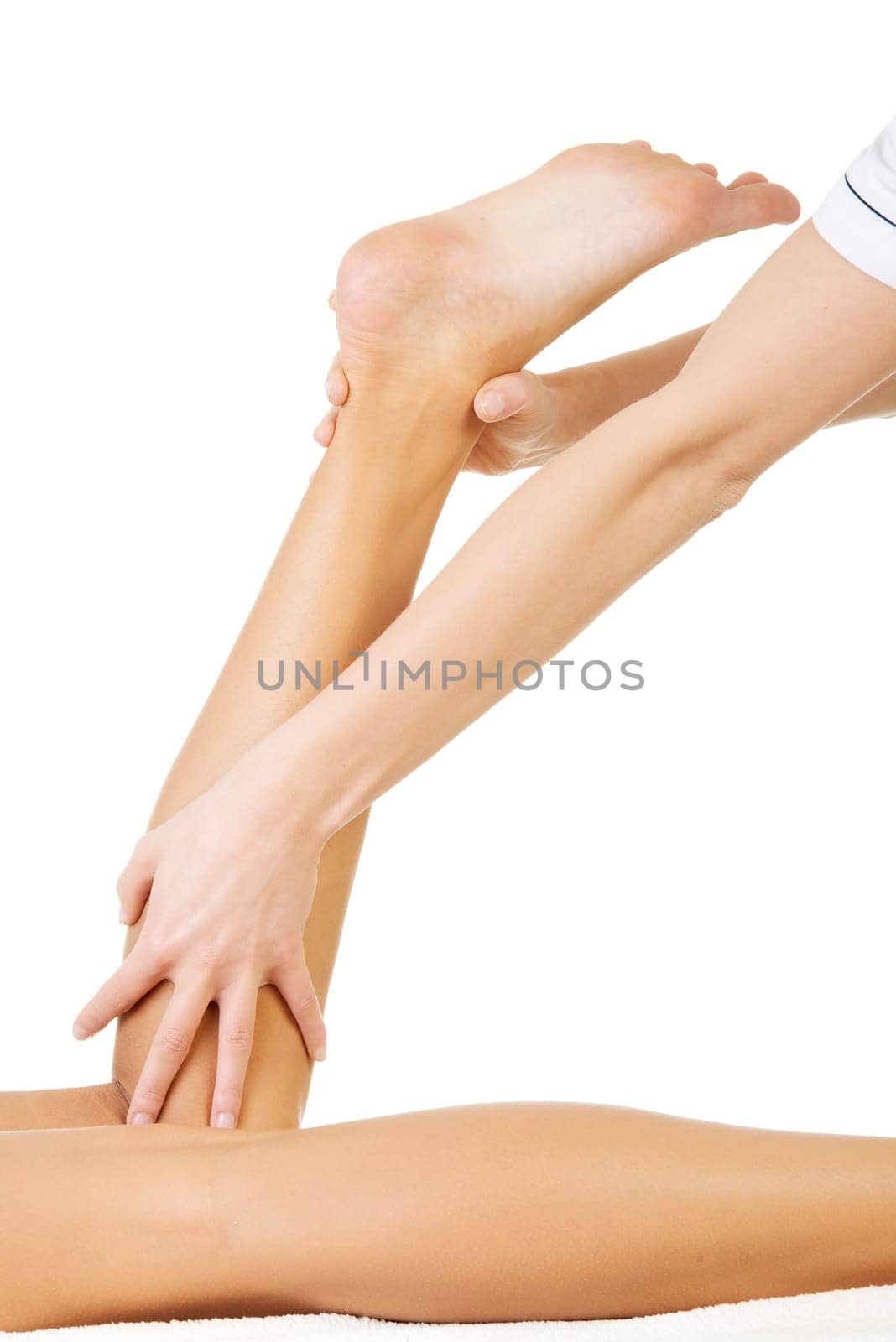 Physio therapist trying to fix the leg over white background