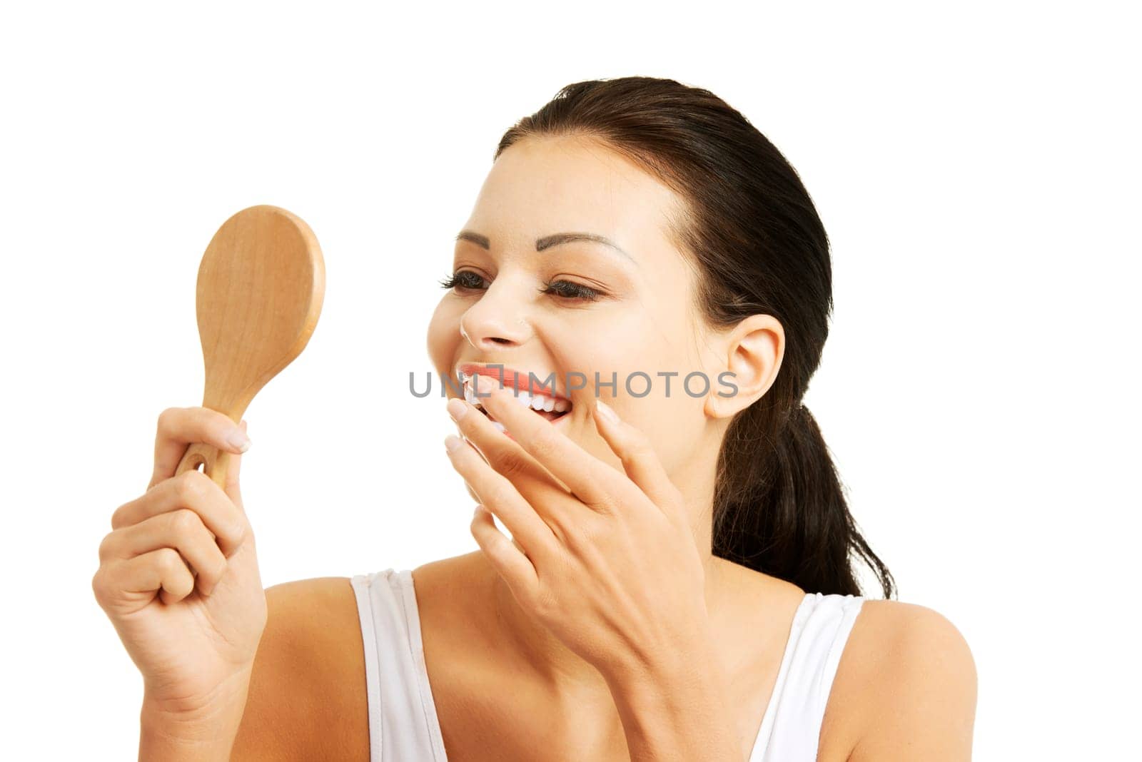 Young beautiful woman looking in a mirror