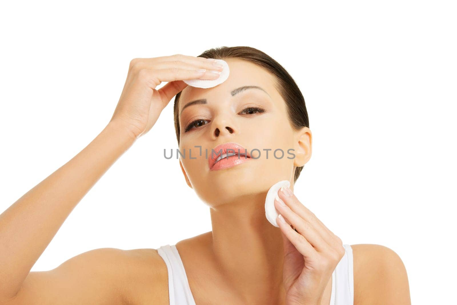 Beautiful woman using cotton pad , isolated on white