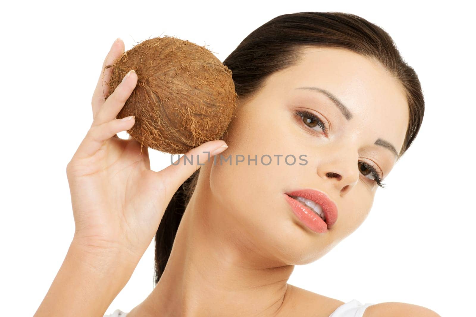 Beautiful woman with coconut in hands over white background