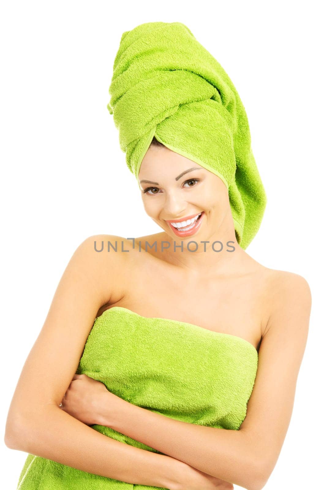 Beautiful happy woman after bath or spa, covered by green towel