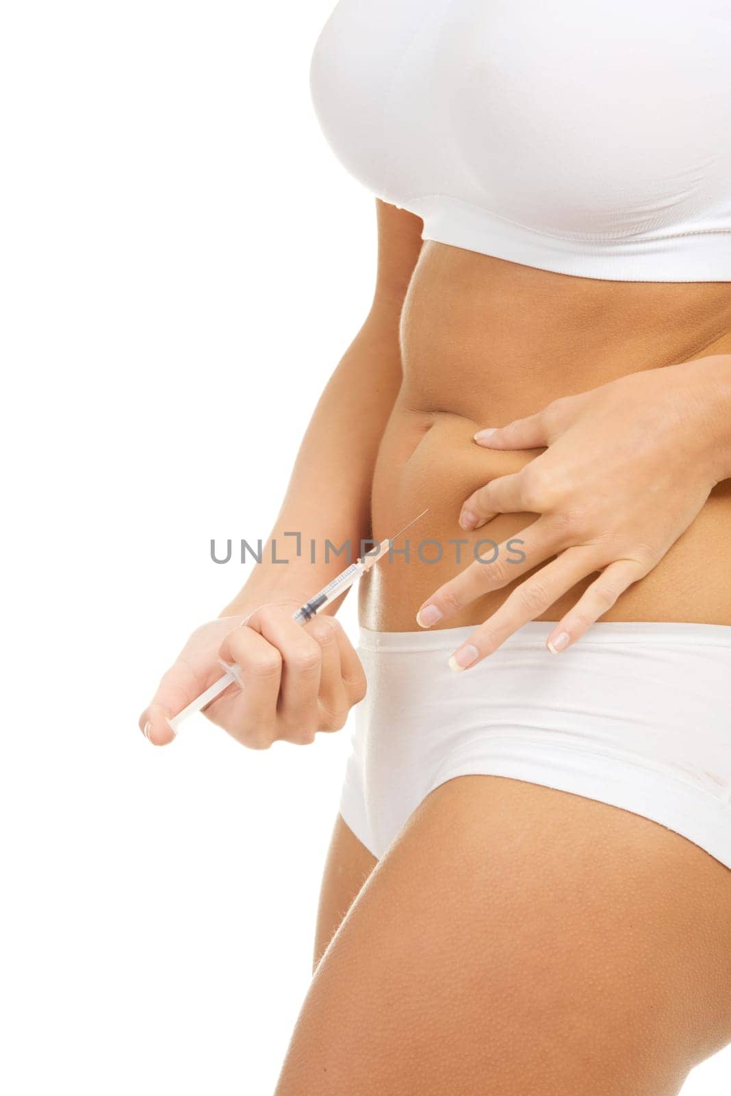 Close up of woman doing insulin injection in her belly, isolated on white