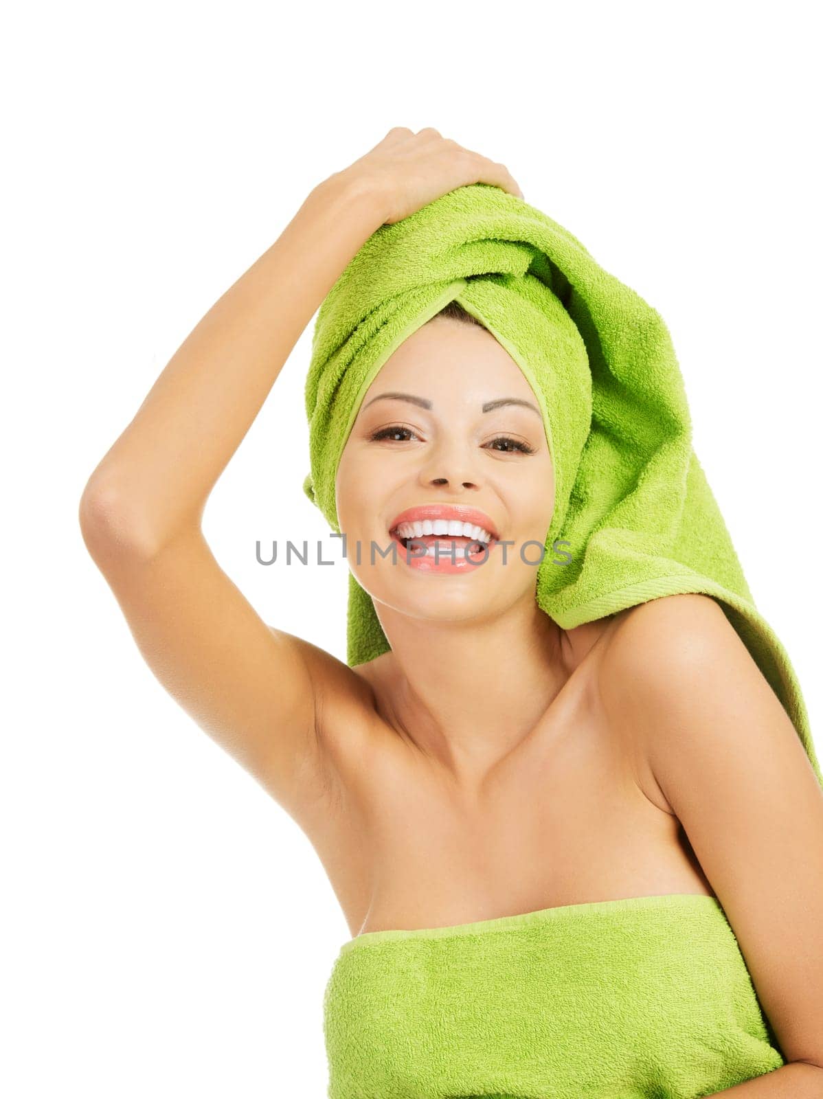 Beautiful happy woman after bath or spa, covered by green towel
