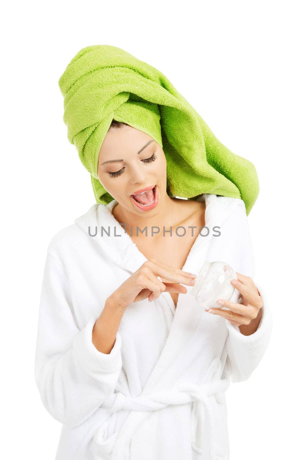 Attractive fit woman with moisturizer cream. Isolated on white background