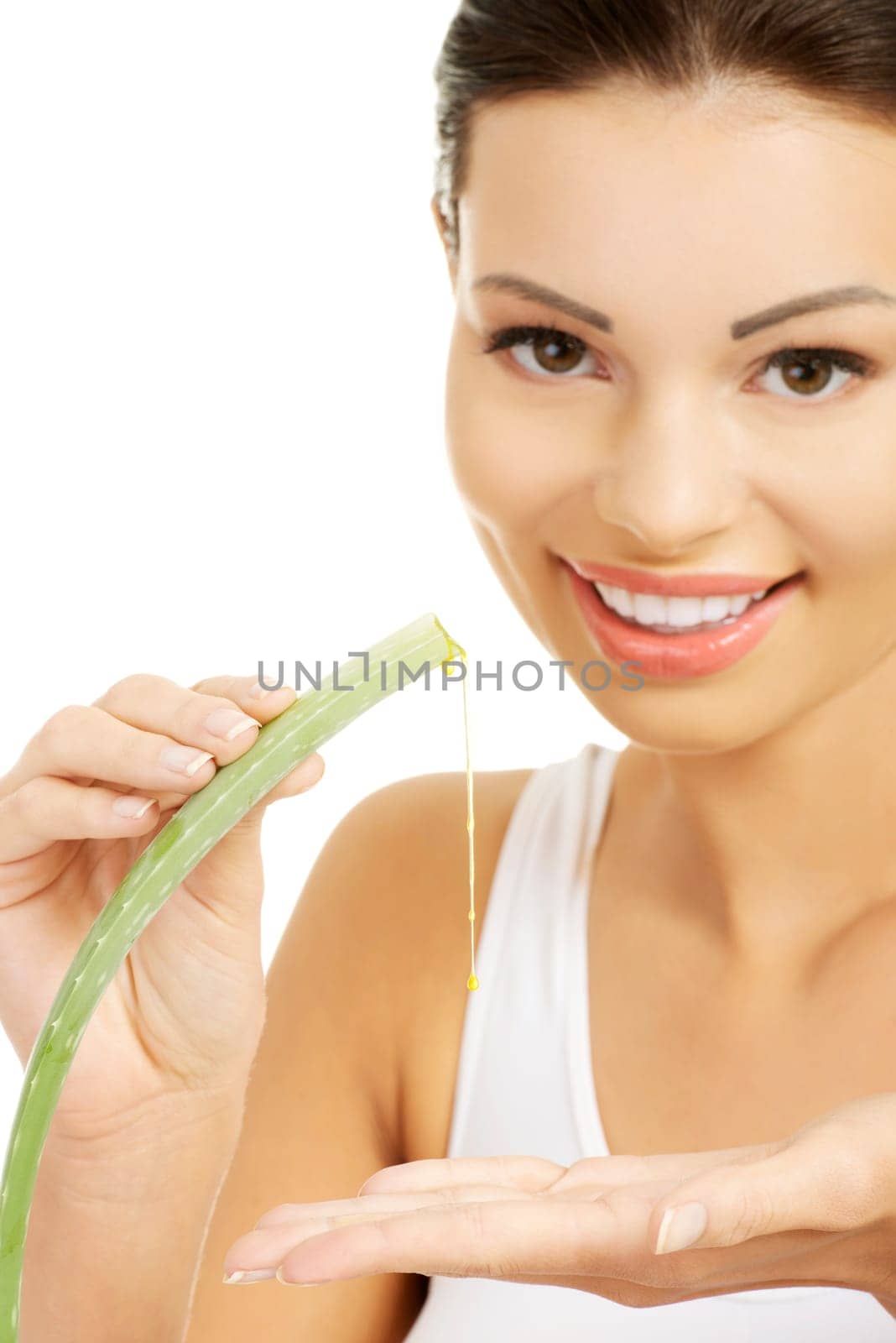 Young beautiful woman's face and aloe vera. Isolated on white background