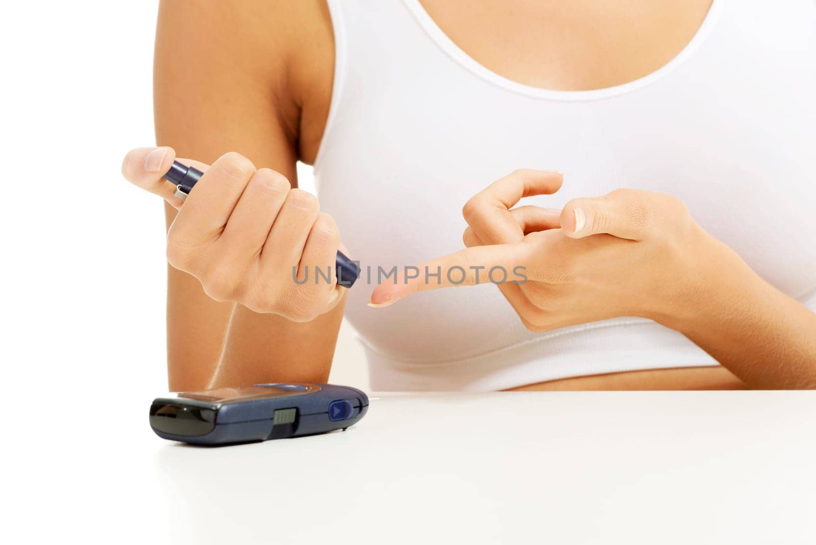 Diabetes patient measuring glucose level blood test using ultra mini glucometer and small drop of blood from finger isolated on a white background