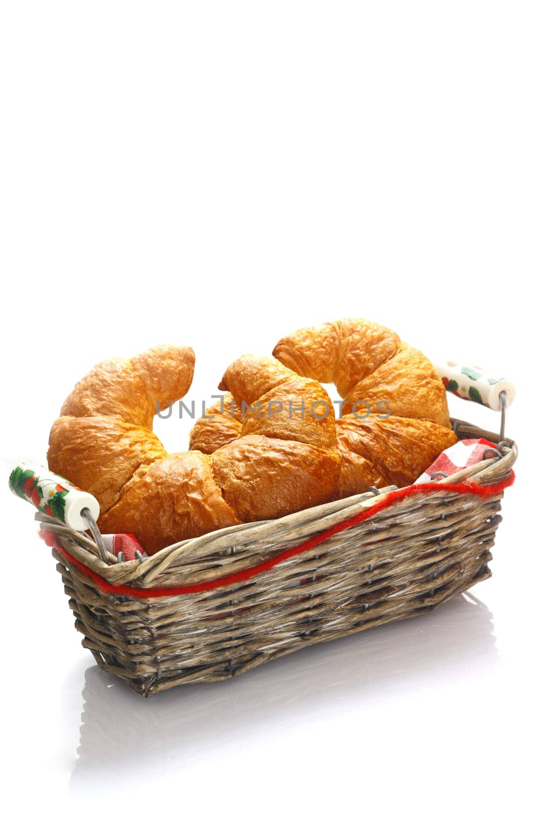 Crisp golden croissants served in a basket for breakfast or as an accompaniment to a meal