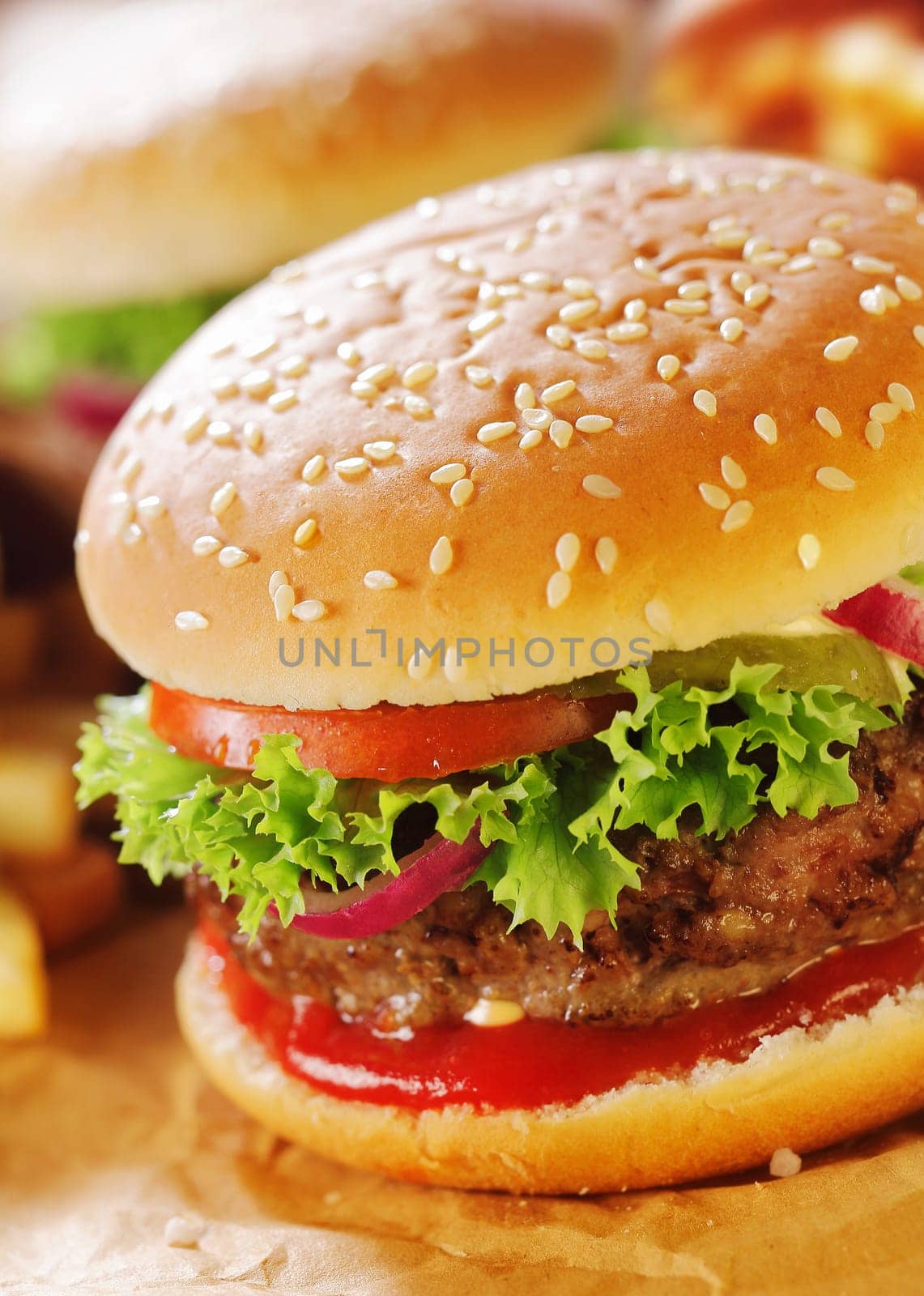Close-up of hamburger with sesame bun and lettuce