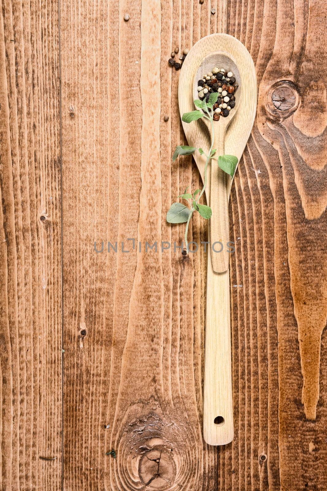 Brown wooden spoon and a sprig of green