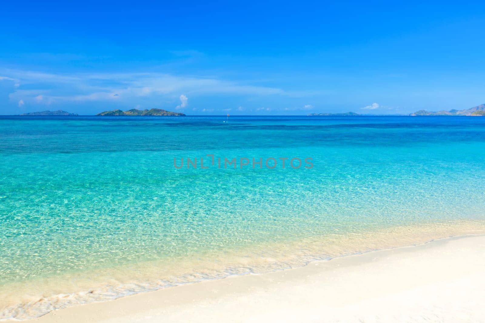 Tropical sandy beach Malcapuya at summer sunny day