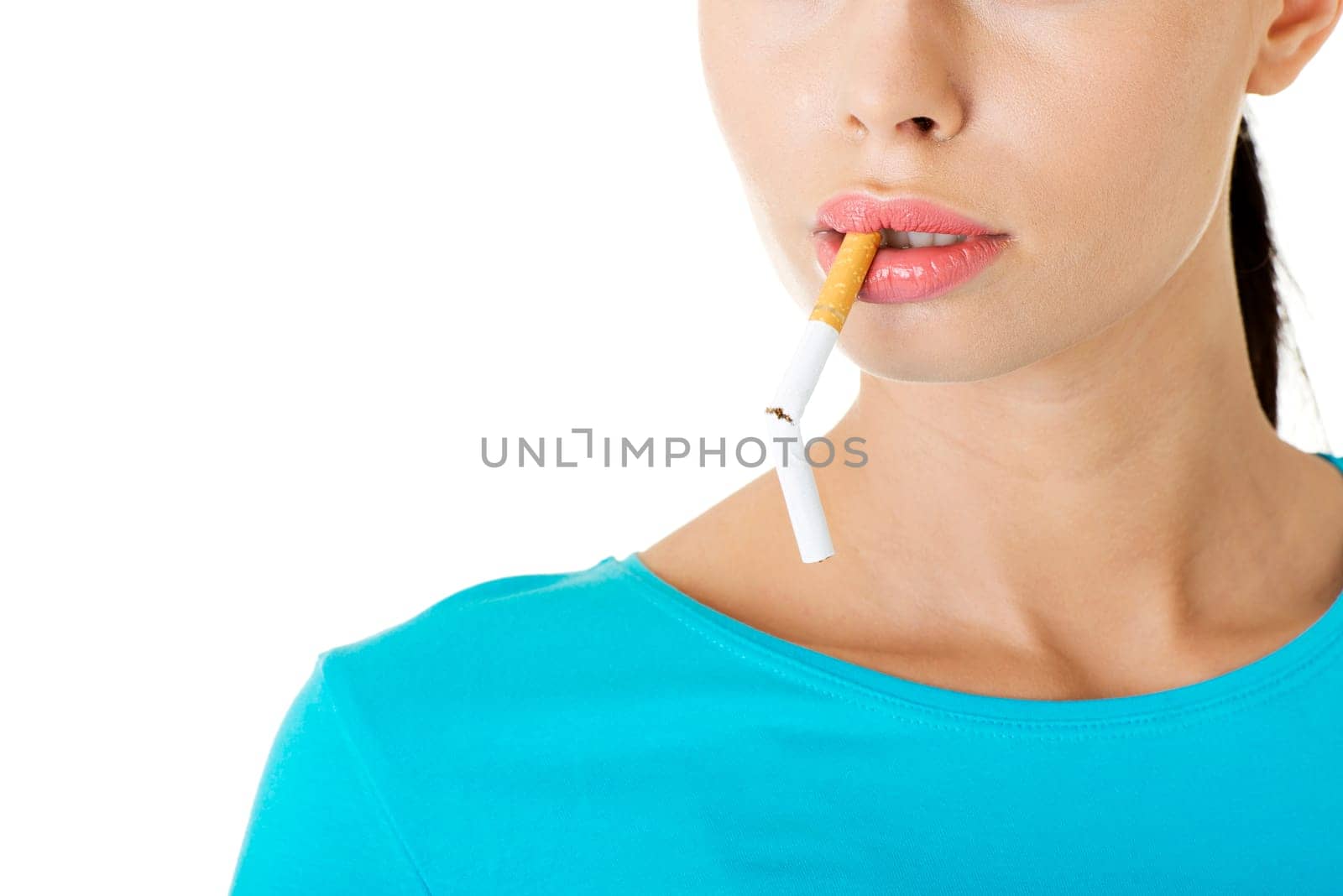 Young woman with broken cigarette. Stop smoking concept.