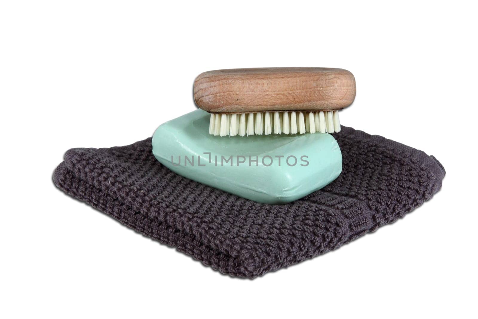 A simple mans face wash collection isolated over white. Includes face cloth, bar of soap, and a scrub brush.