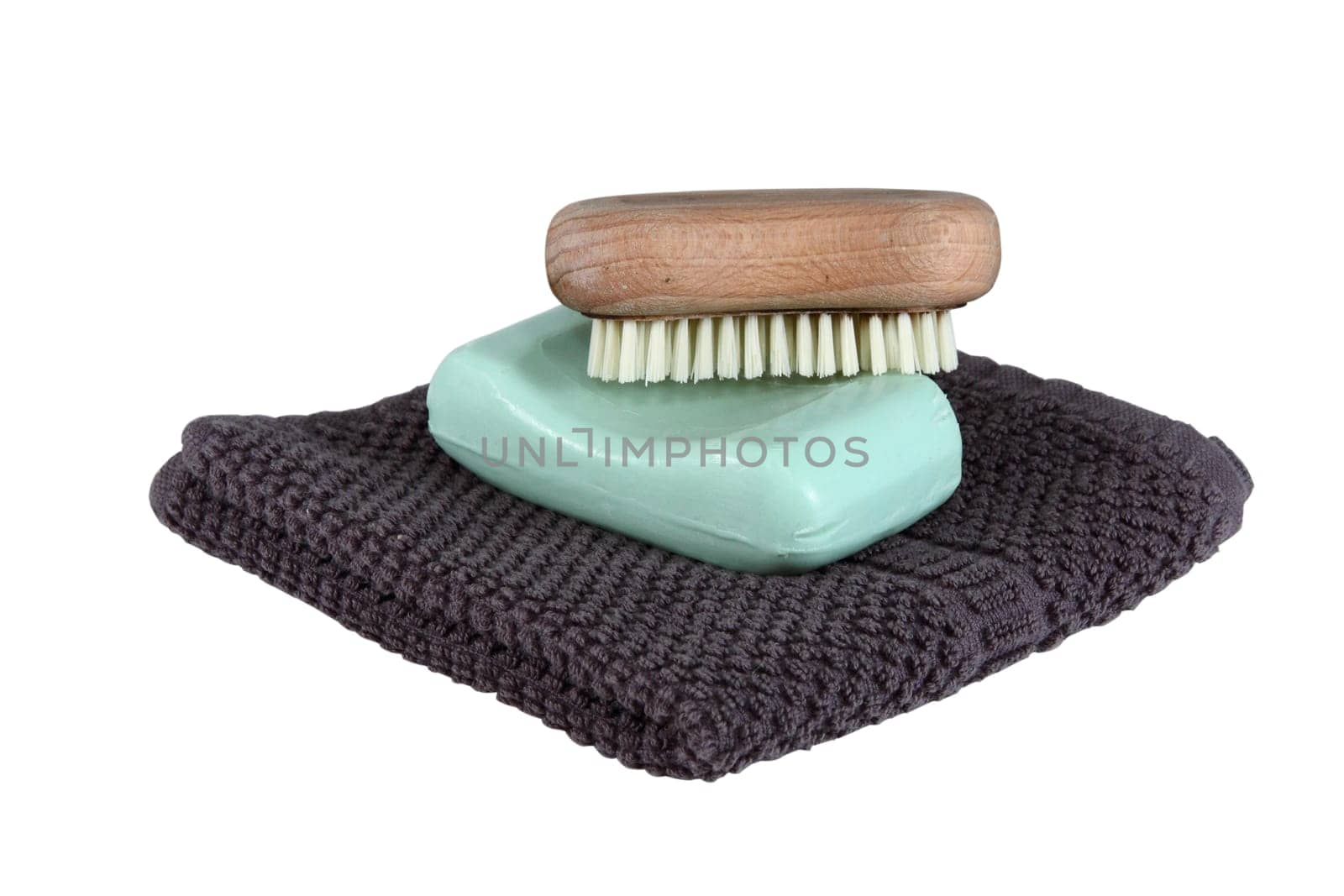 A simple mans face wash collection isolated over white. Includes face cloth, bar of soap, and a scrub brush.