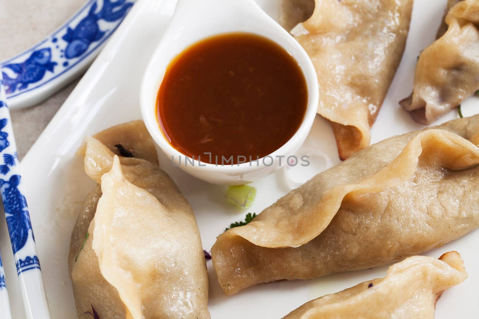 Potstickers appetizer with orange soy sauce.
