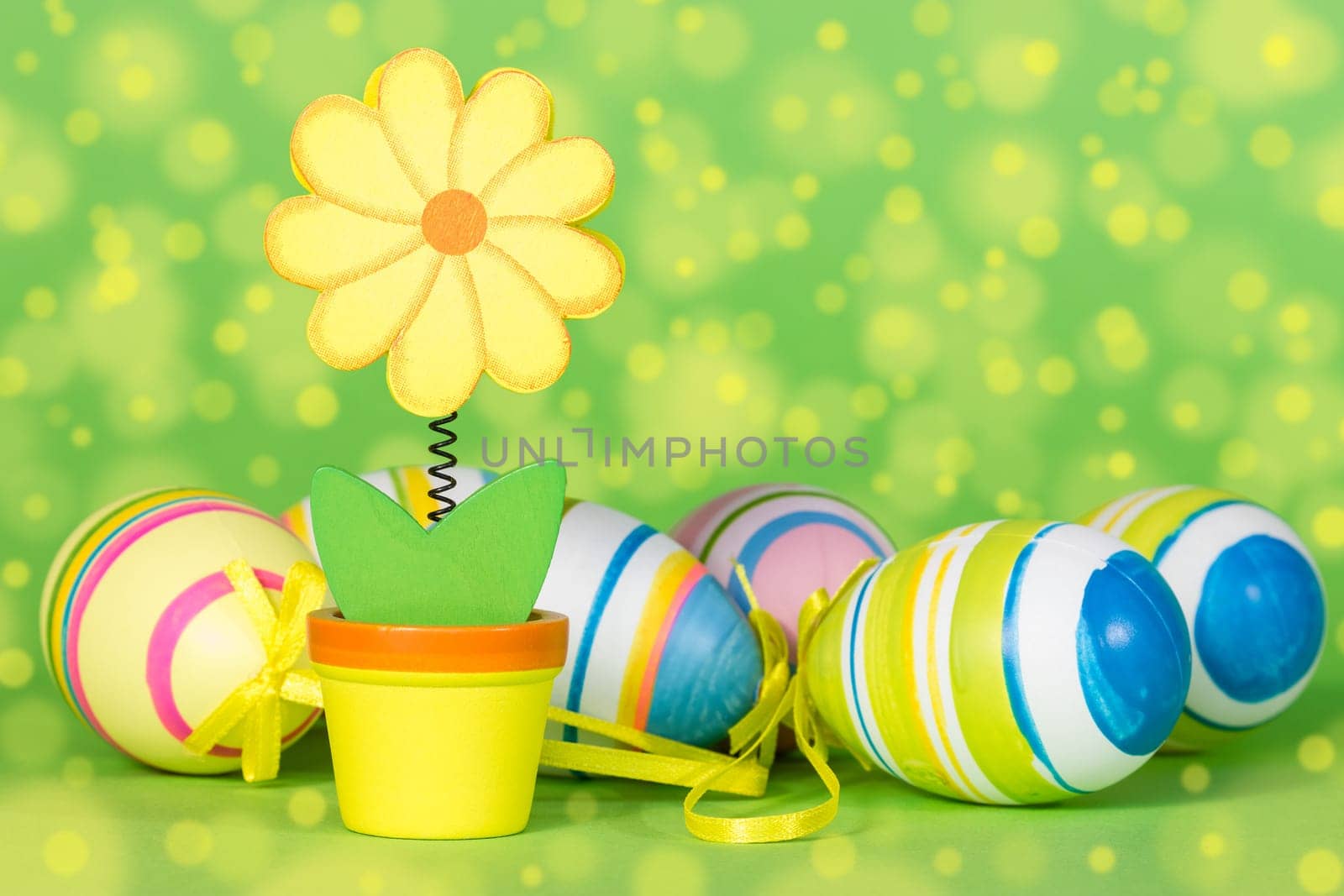 Decorative flower and Easter eggs on the green background