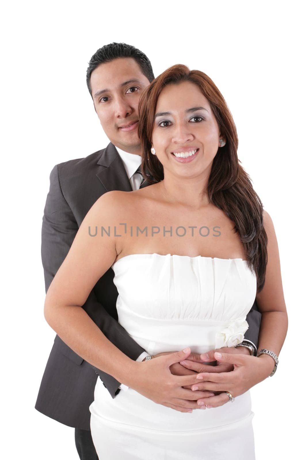 Happy young man hugging his girlfriend isolated on white background.  Focus in the woman.