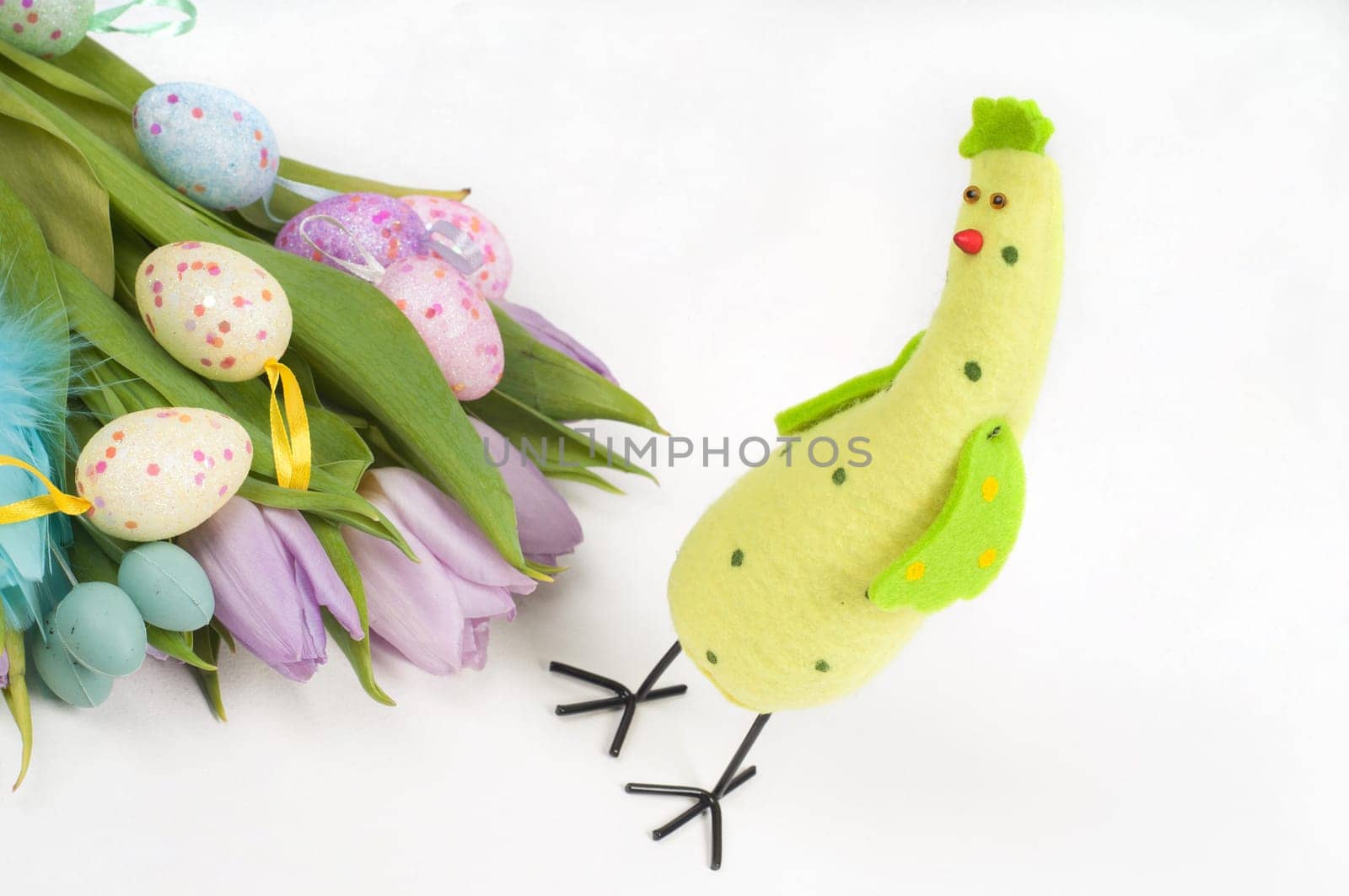 Easter chicken with tulips and eggs on light background