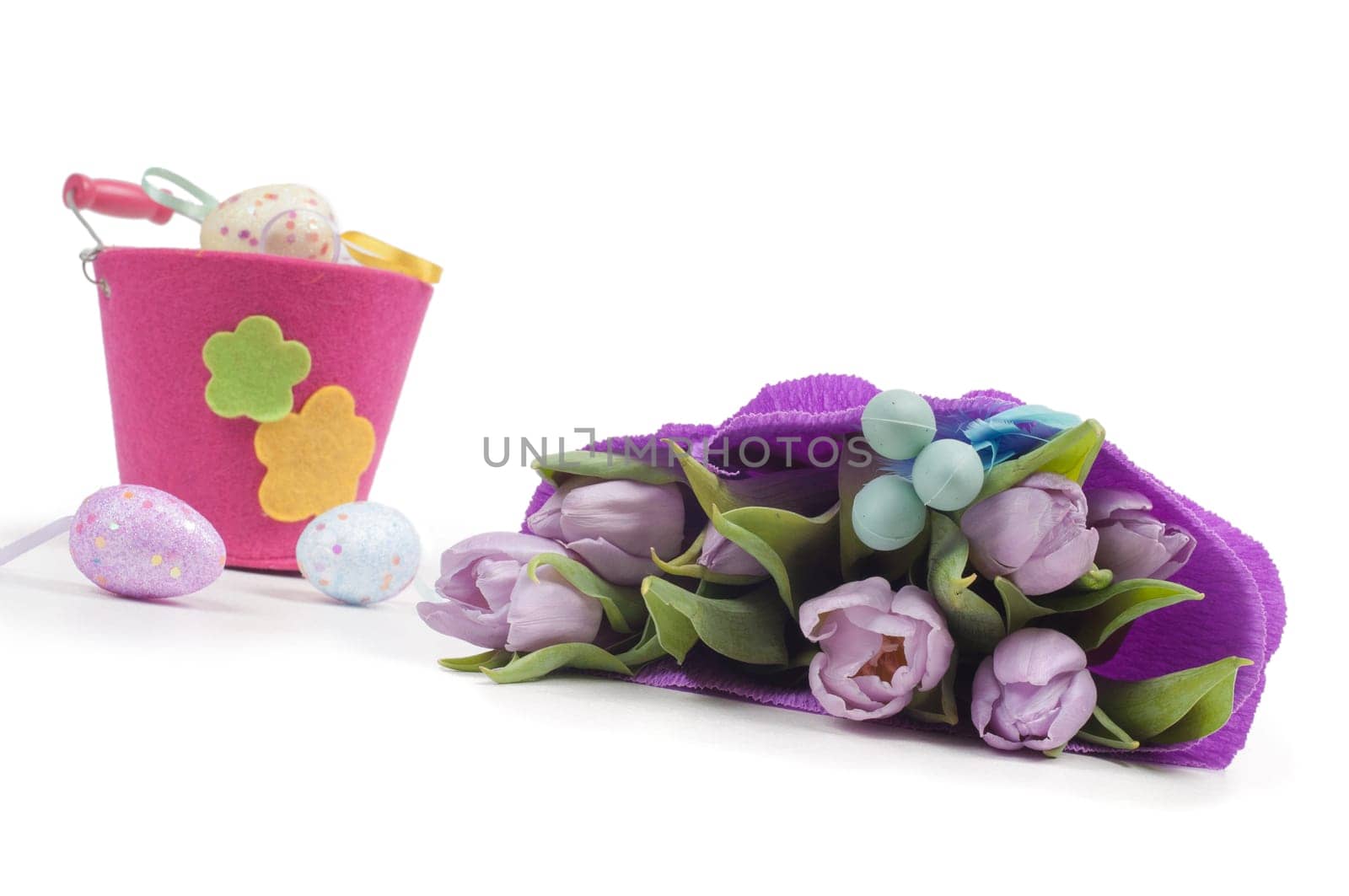 Easter eggs with bucket and tulips isolated on white