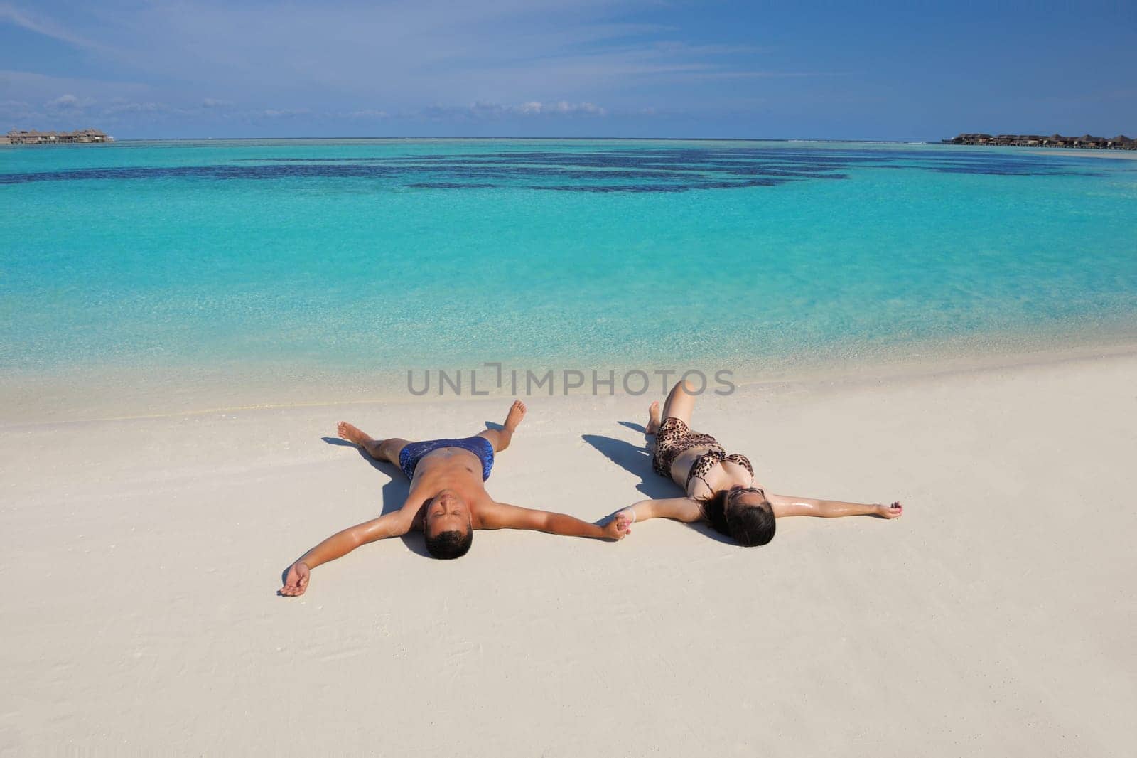 happy young asian couple have fun and romantic time at  summer on beautiful white sand beach