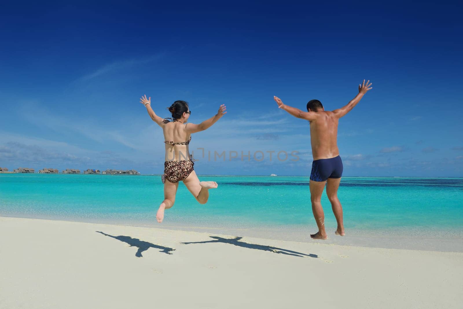 happy young asian couple have fun and romantic time at  summer on beautiful white sand beach