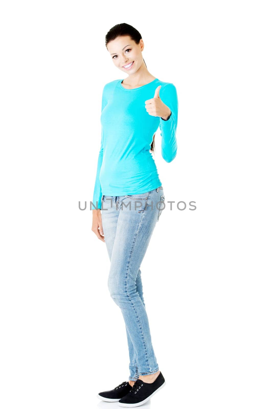 Beautiful young woman in casual clothes gesturing thumb up.