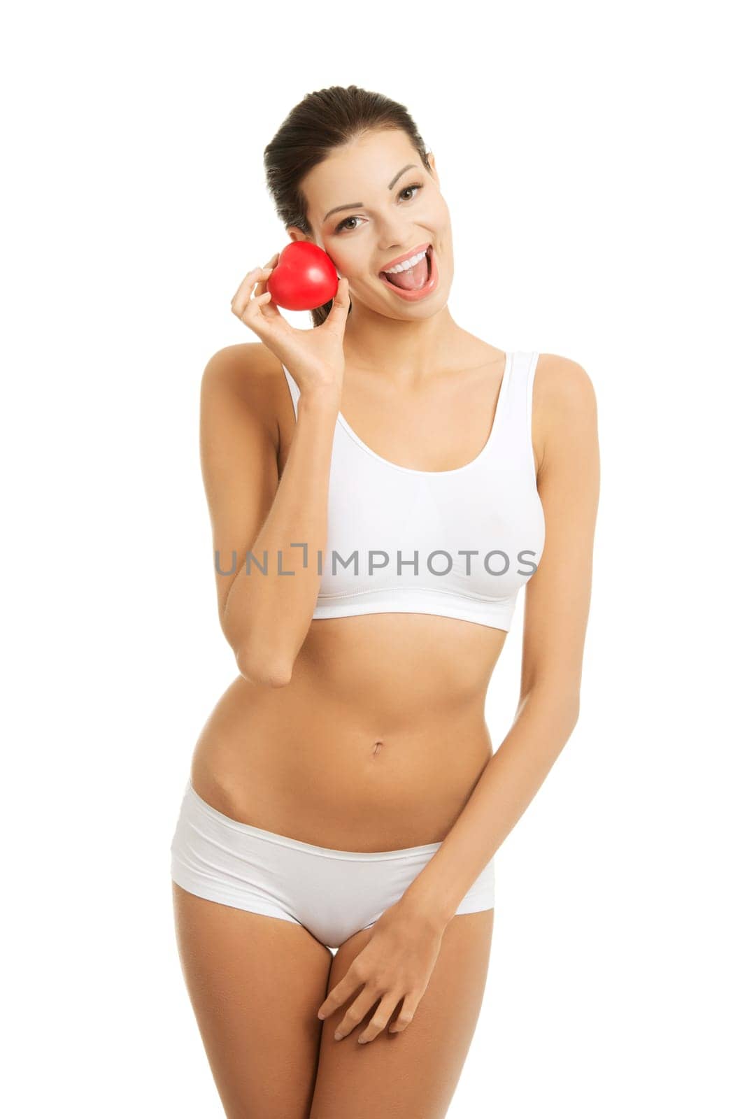 Happy Fit female in white sport underwear with red heart shaped toy