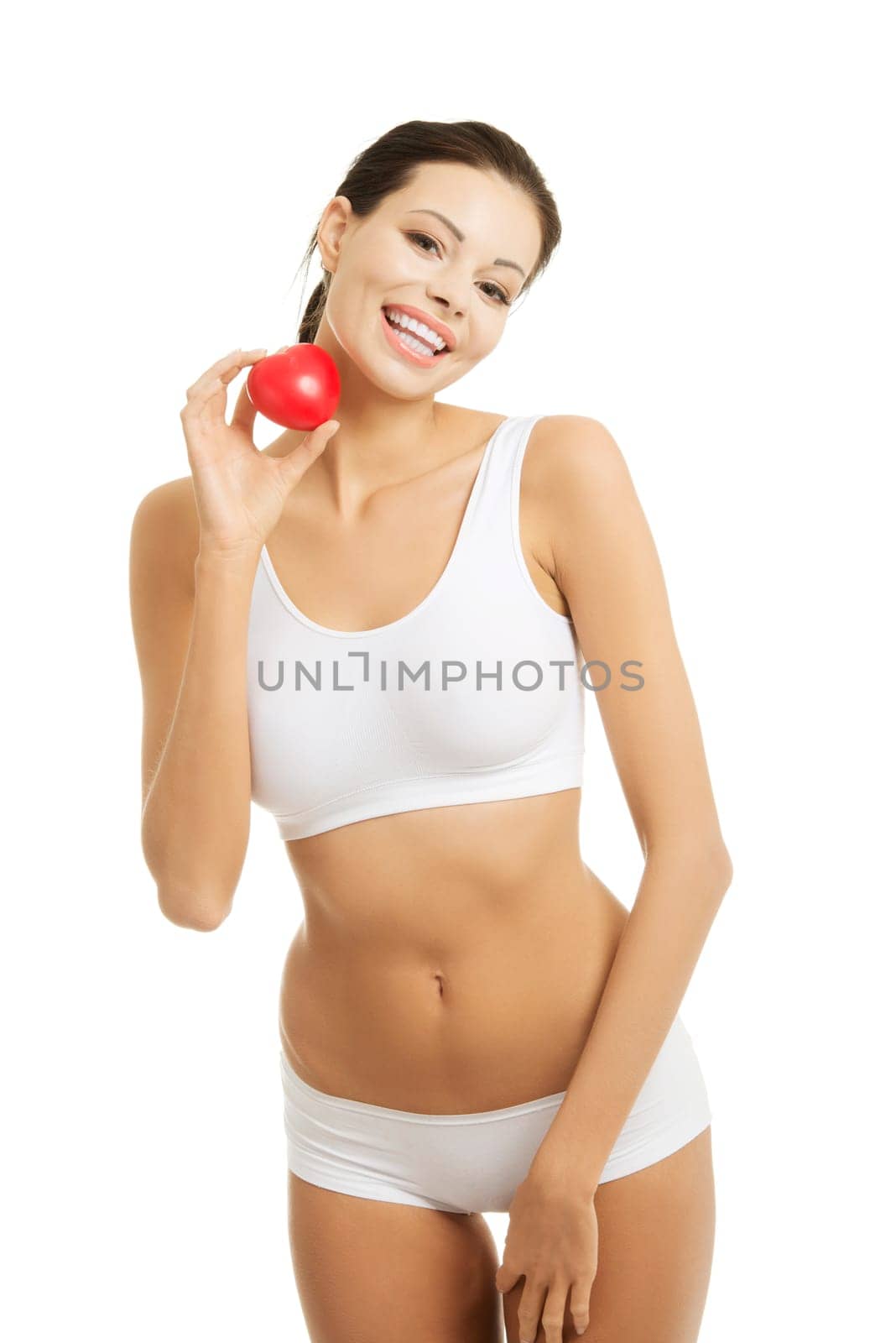 Happy Fit female in white sport underwear with red heart shaped toy