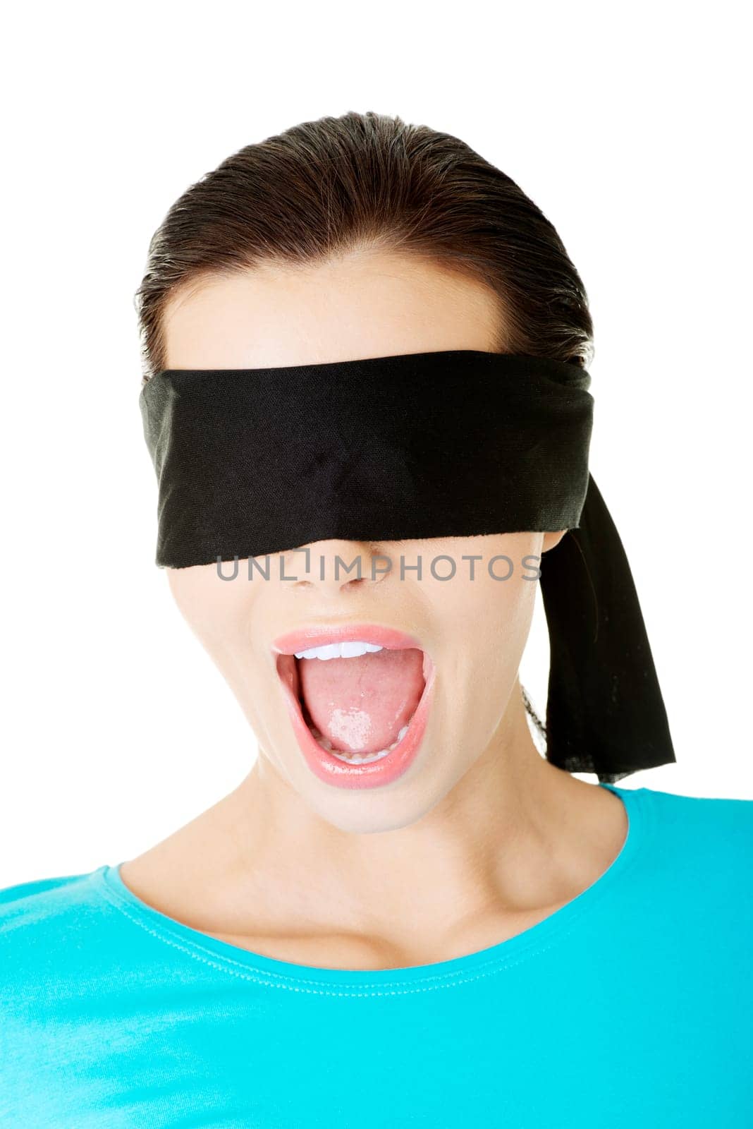 Portrait of a beautiful frighten young blindfold woman screaming
