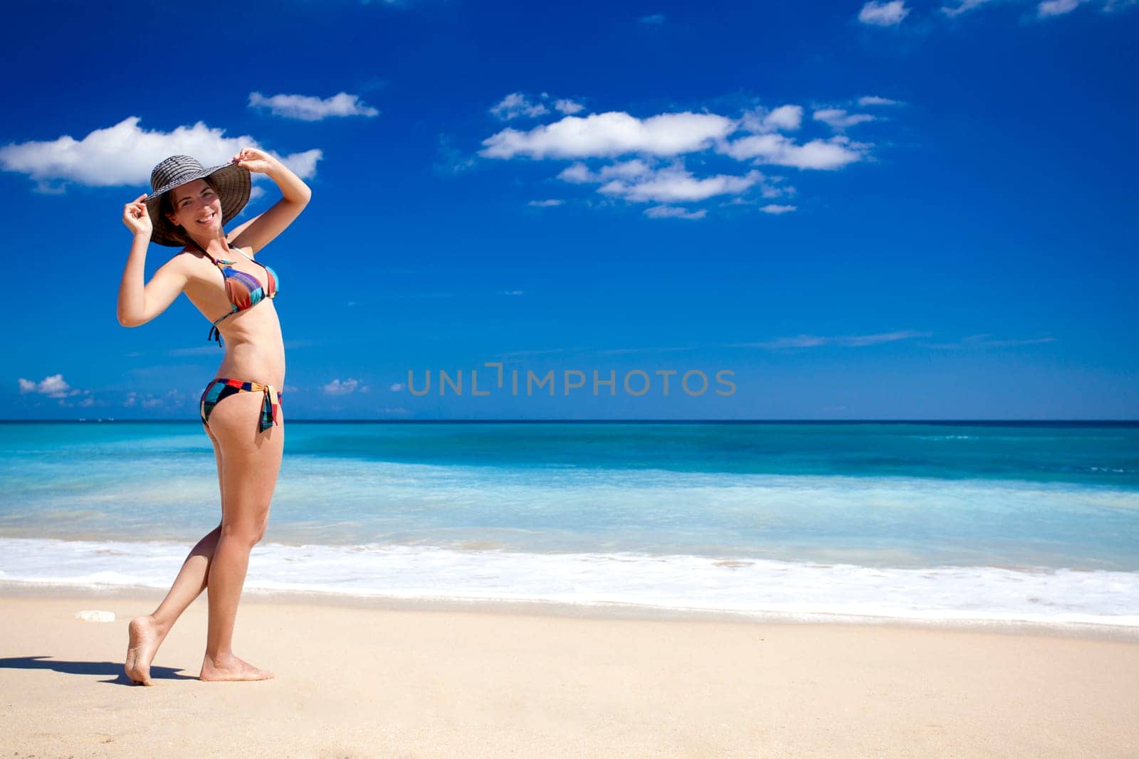 Beautiful young woman enjoying the summer in a tropical beach