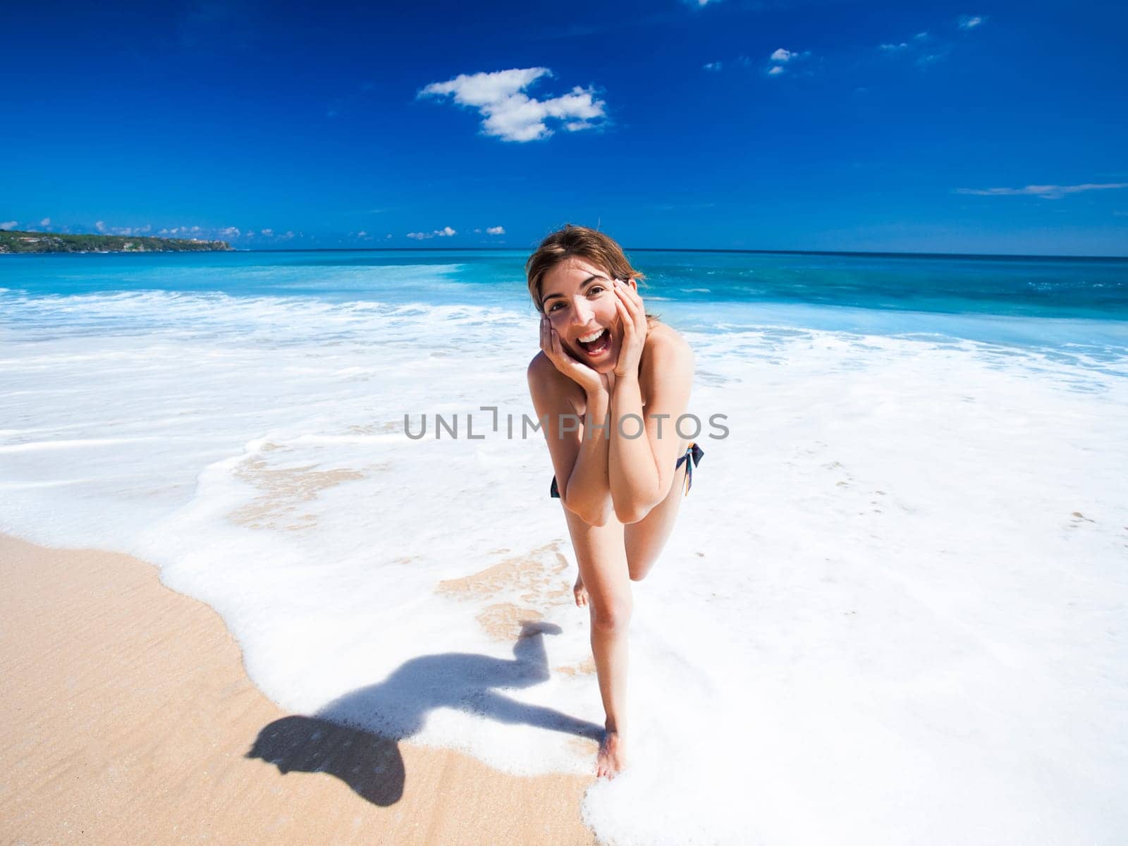 Beautiful and happy young woman  enjoying the summer on a tropical beach