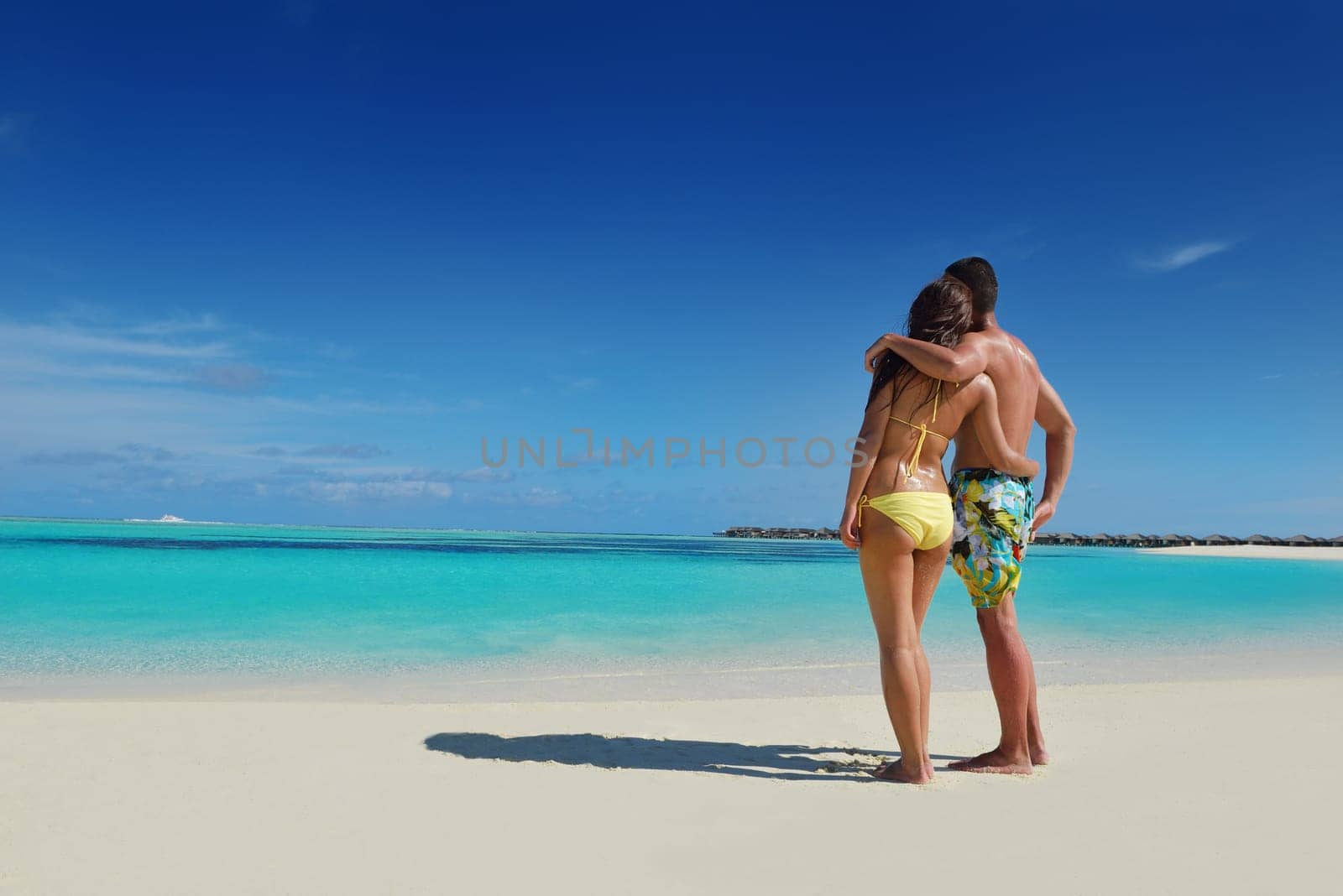 happy young asian couple have fun and romantic time at  summer on beautiful white sand beach