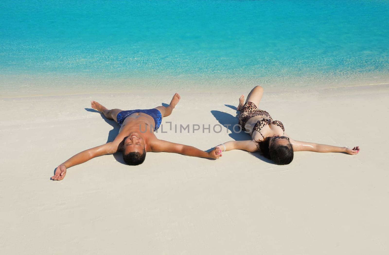 happy young asian couple have fun and romantic time at  summer on beautiful white sand beach