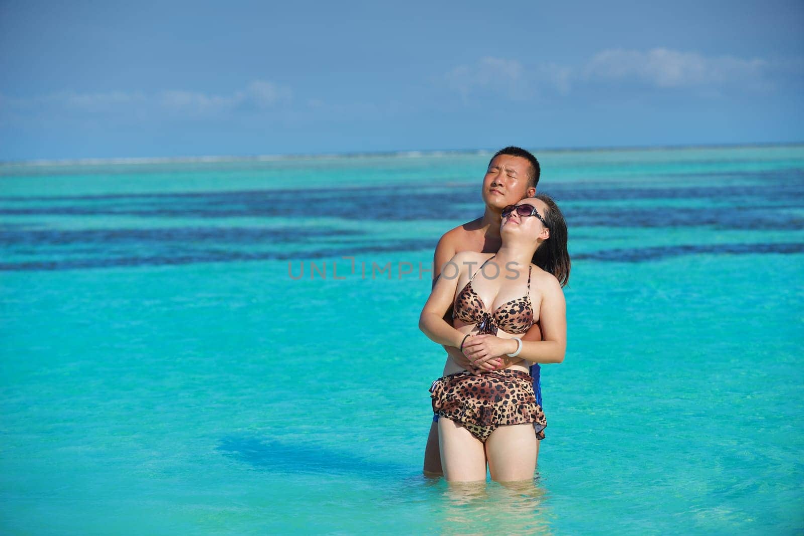happy young asian couple have fun and romantic time at  summer on beautiful white sand beach