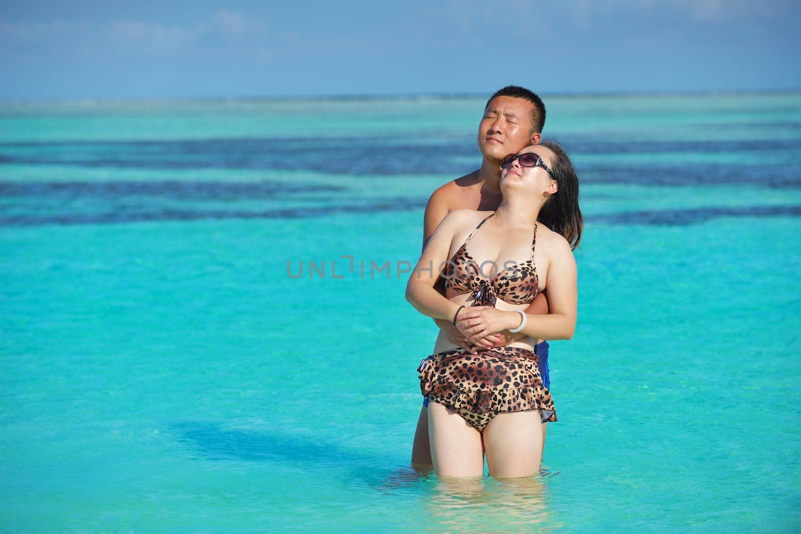 happy young asian couple have fun and romantic time at  summer on beautiful white sand beach