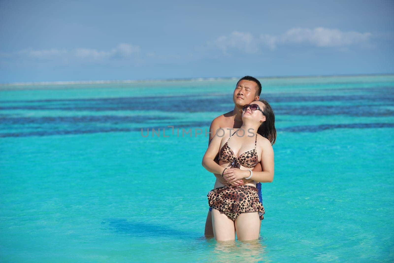 happy young asian couple have fun and romantic time at  summer on beautiful white sand beach
