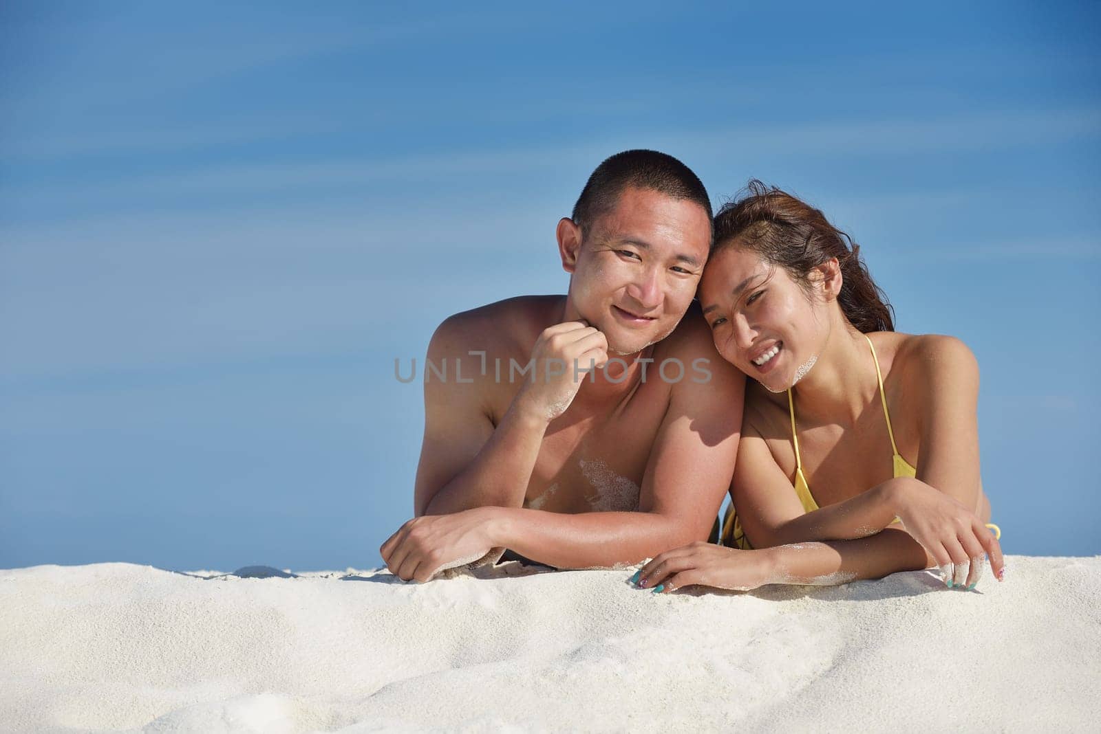 happy young asian couple have fun and romantic time at  summer on beautiful white sand beach