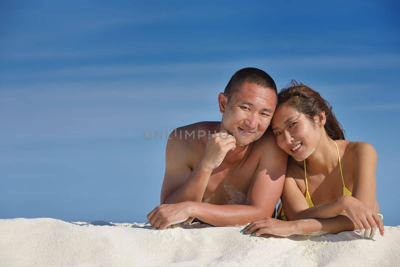 happy young asian couple have fun and romantic time at  summer on beautiful white sand beach