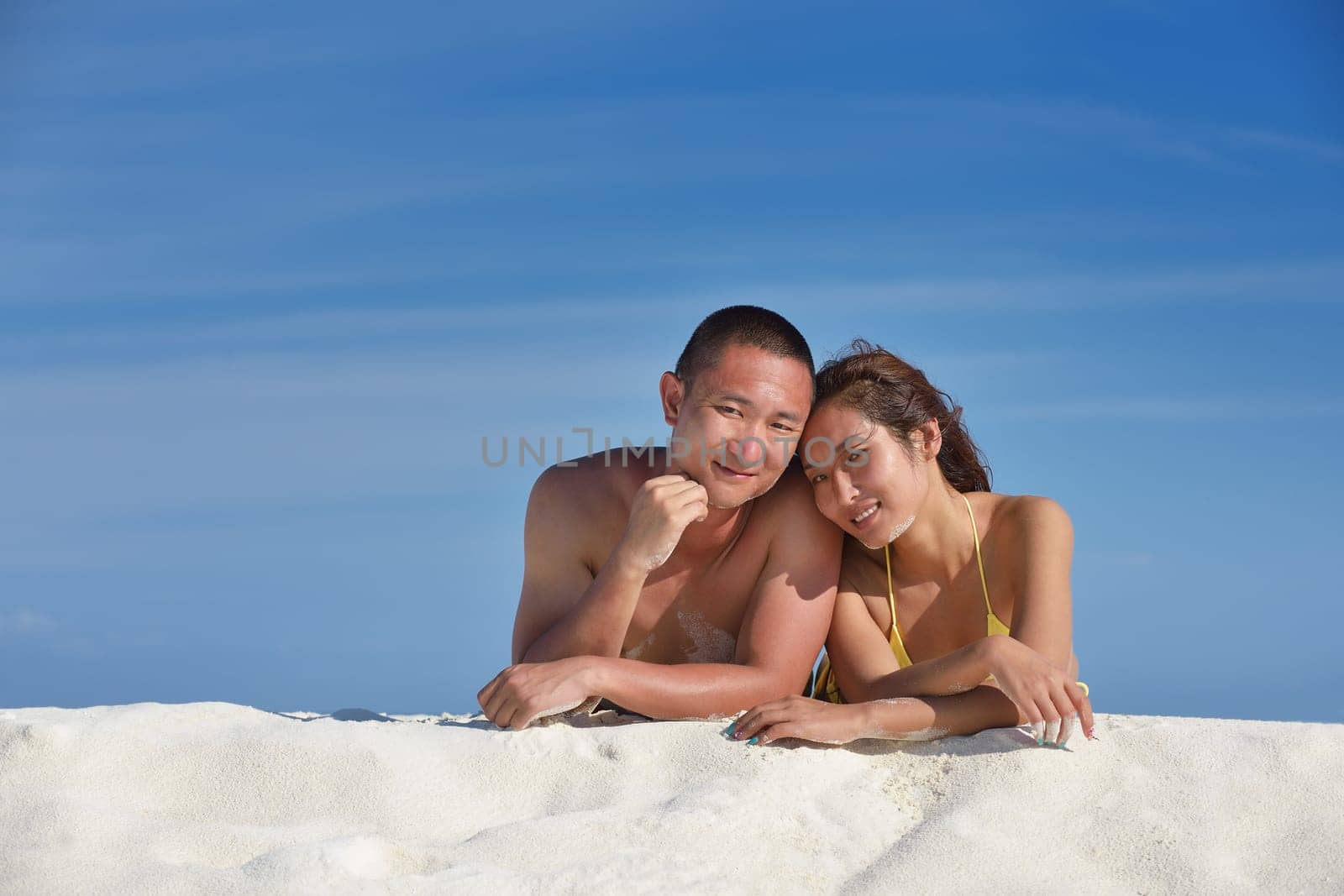 happy young asian couple have fun and romantic time at  summer on beautiful white sand beach