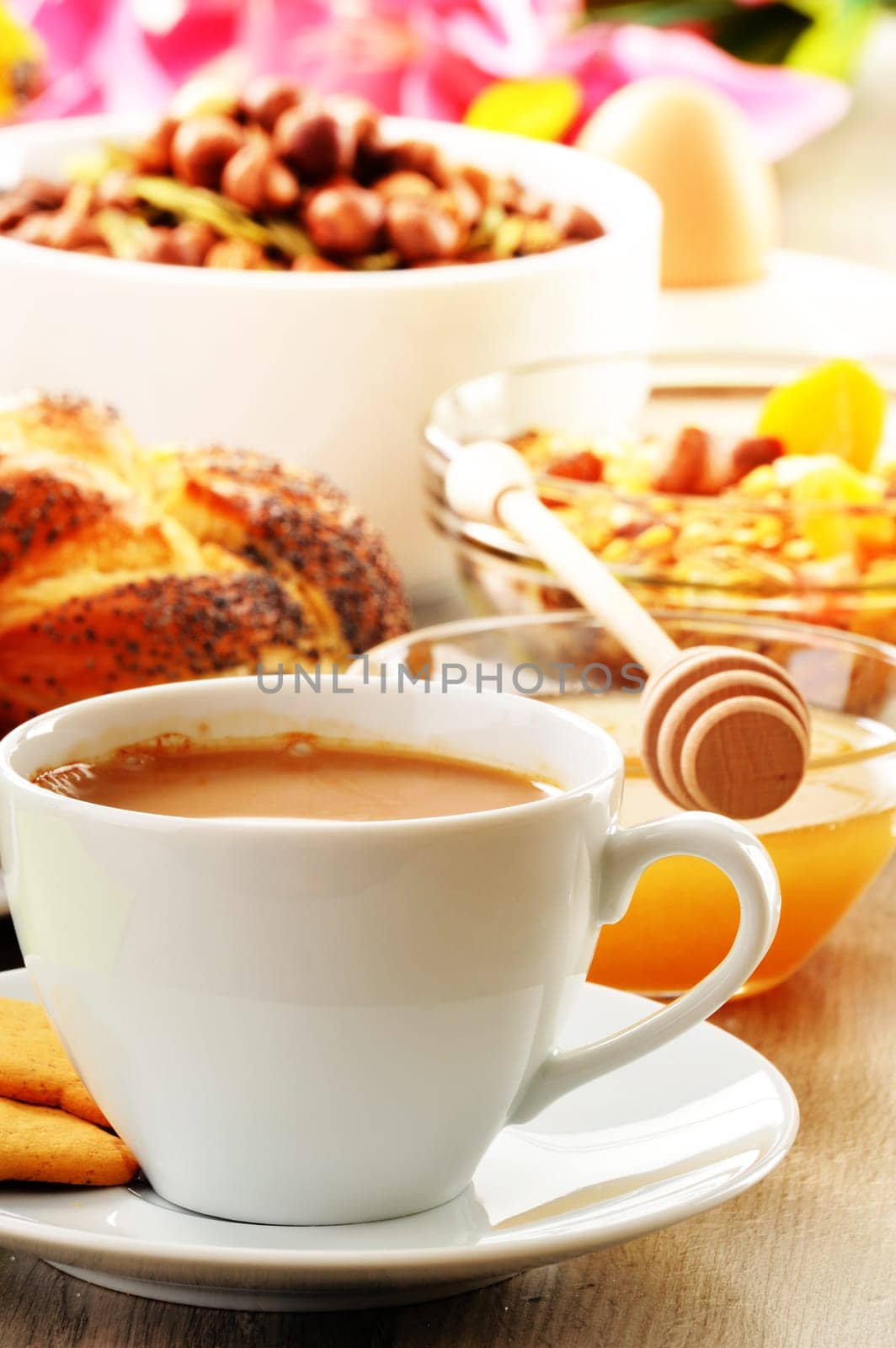 Breakfast including coffee, bread, honey, orange juice, muesli and fruits
