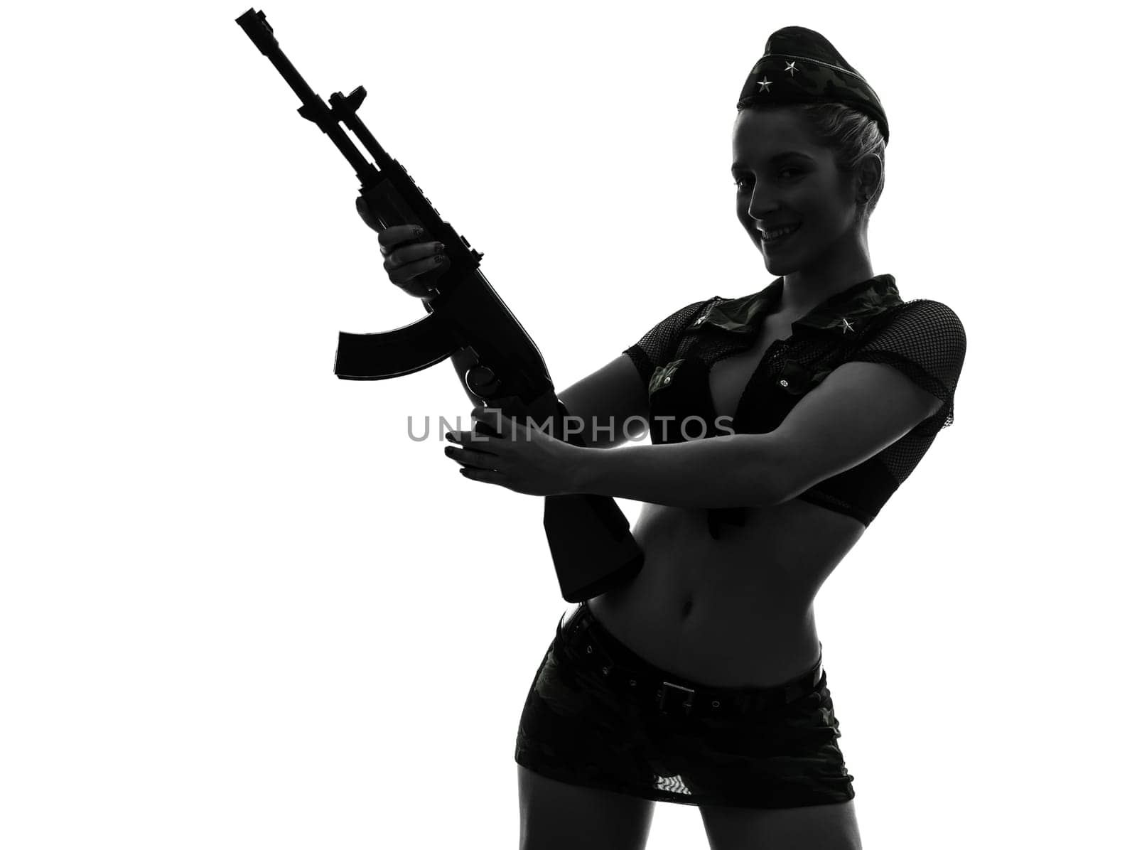 one caucasian sexy woman in army uniform holding kalachnikov in silhouette studio isolated on white background