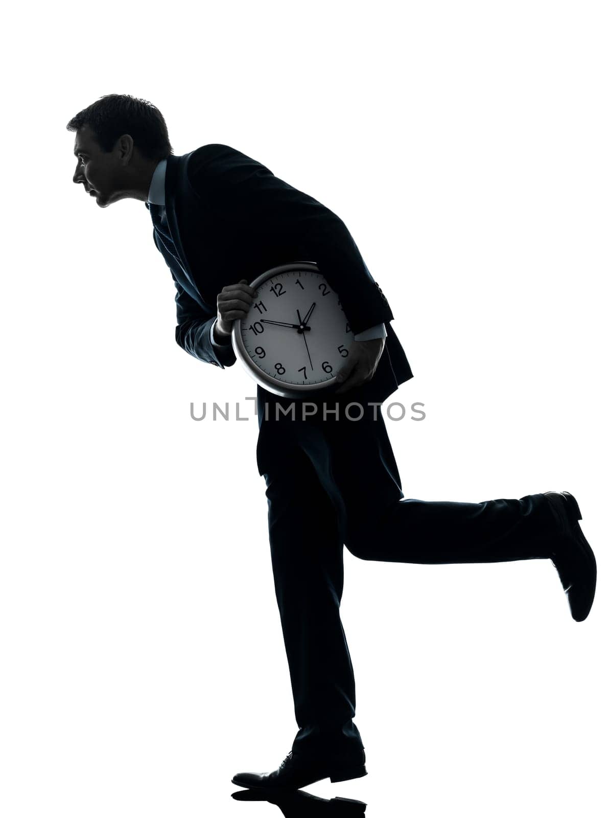 one caucasian businessman holding clock robbing time  in silhouette studio isolated on white background