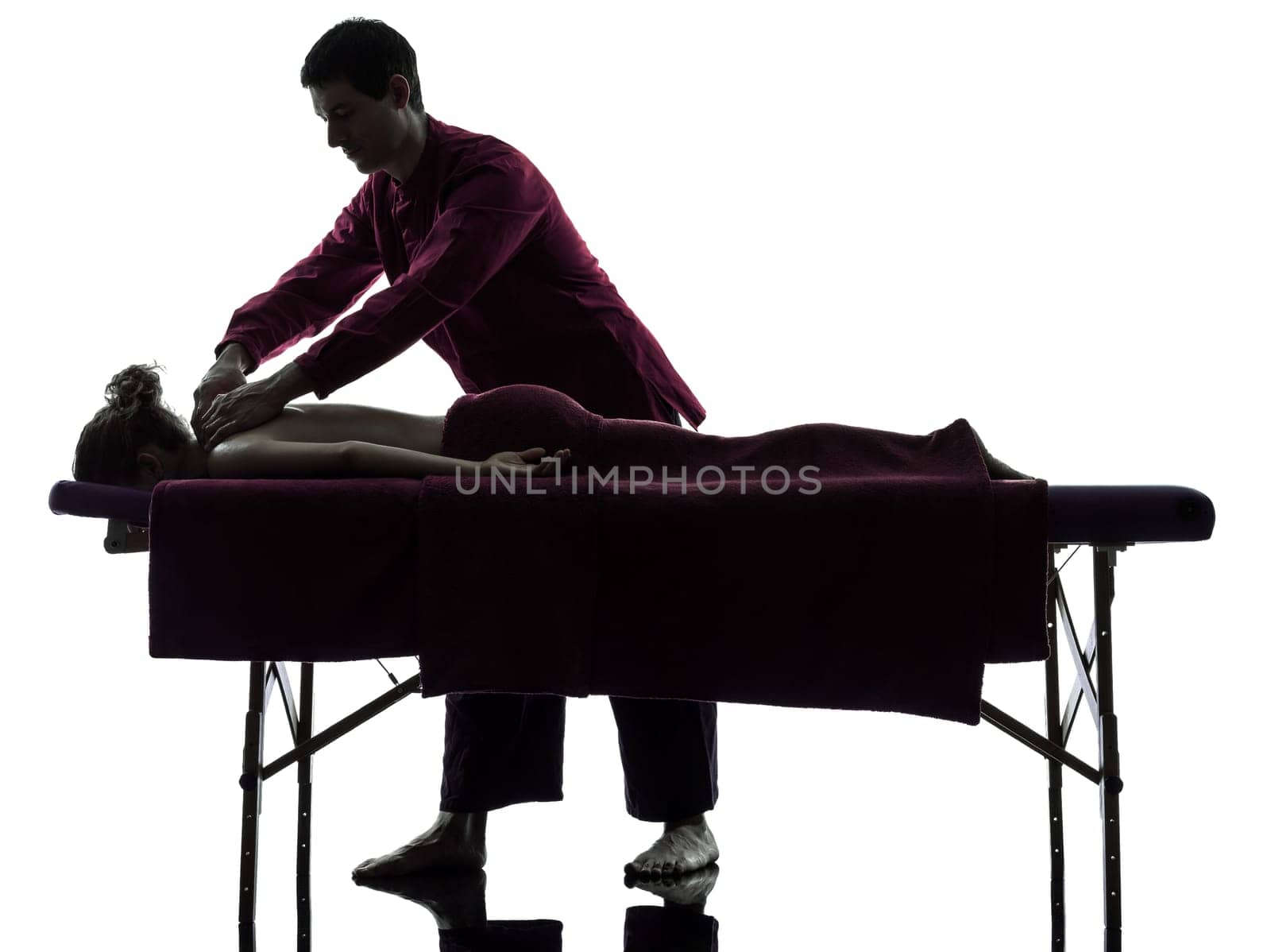 man woman back massage in silhouette studio on white background