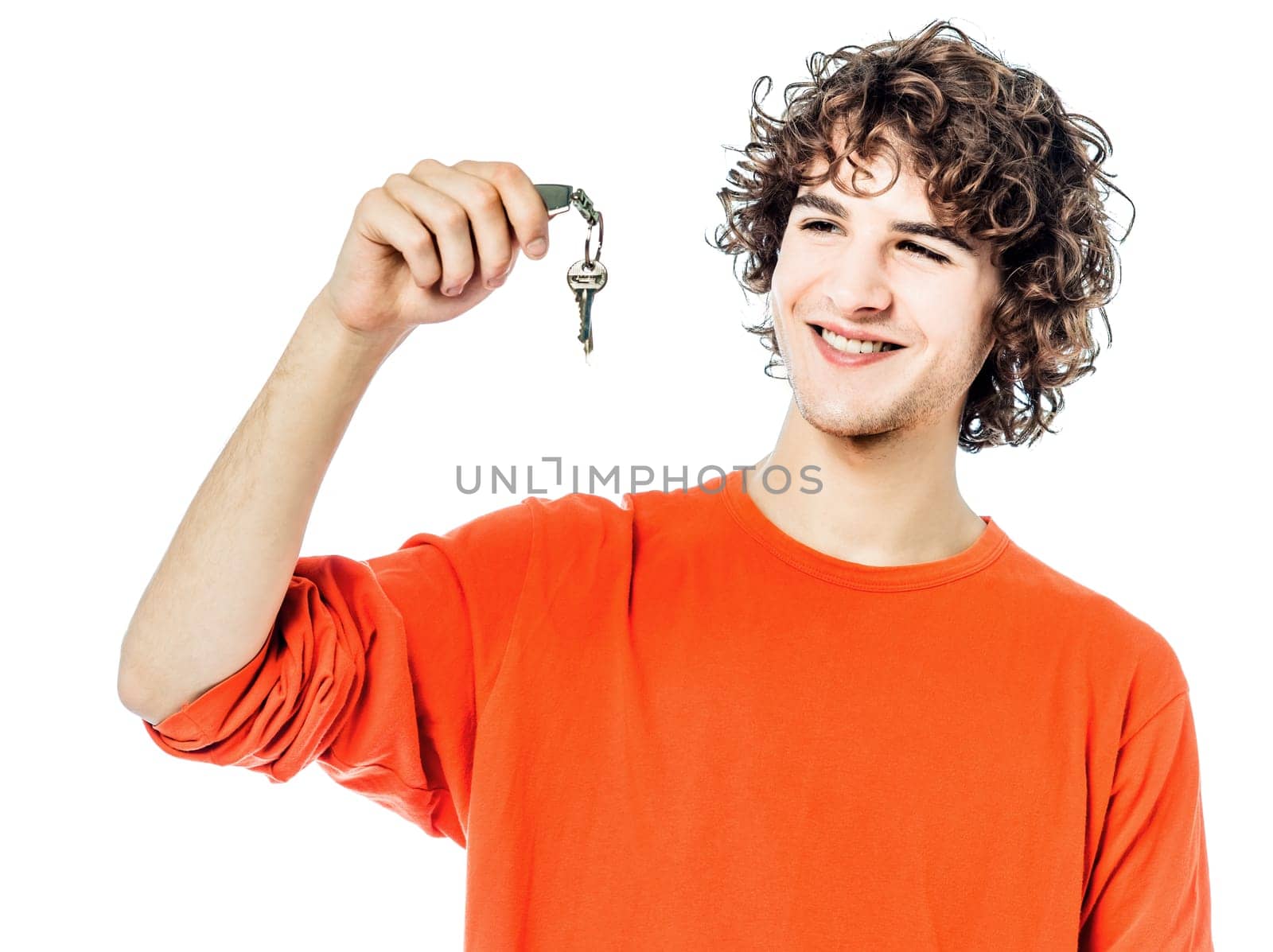 one young man caucasian holding keys portrait  in studio white background