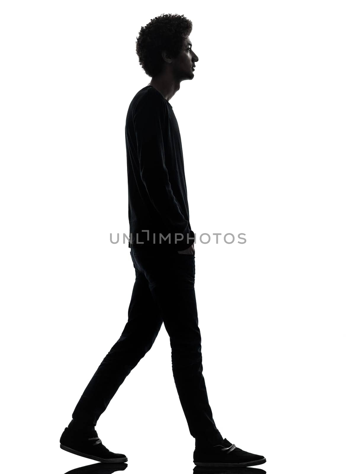 one african handsome young man walking  in silhouette studio isolated on white background