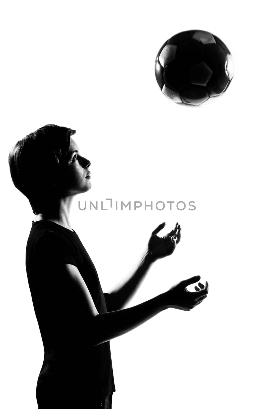 one caucasian young teenager silhouette boy girl tossing soccer football portrait in studio cut out isolated on white background
