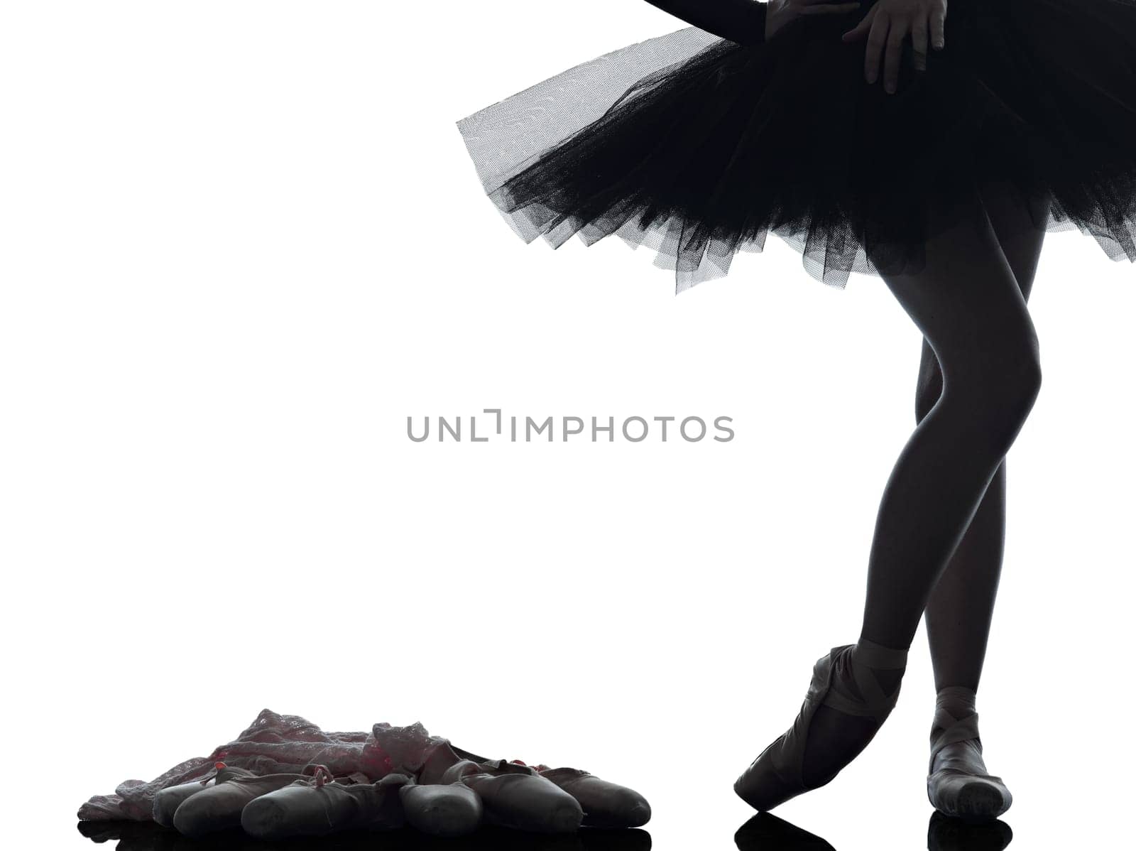 one caucasian young woman ballerina ballet dancer dancing with tutu in silhouette studio on white background