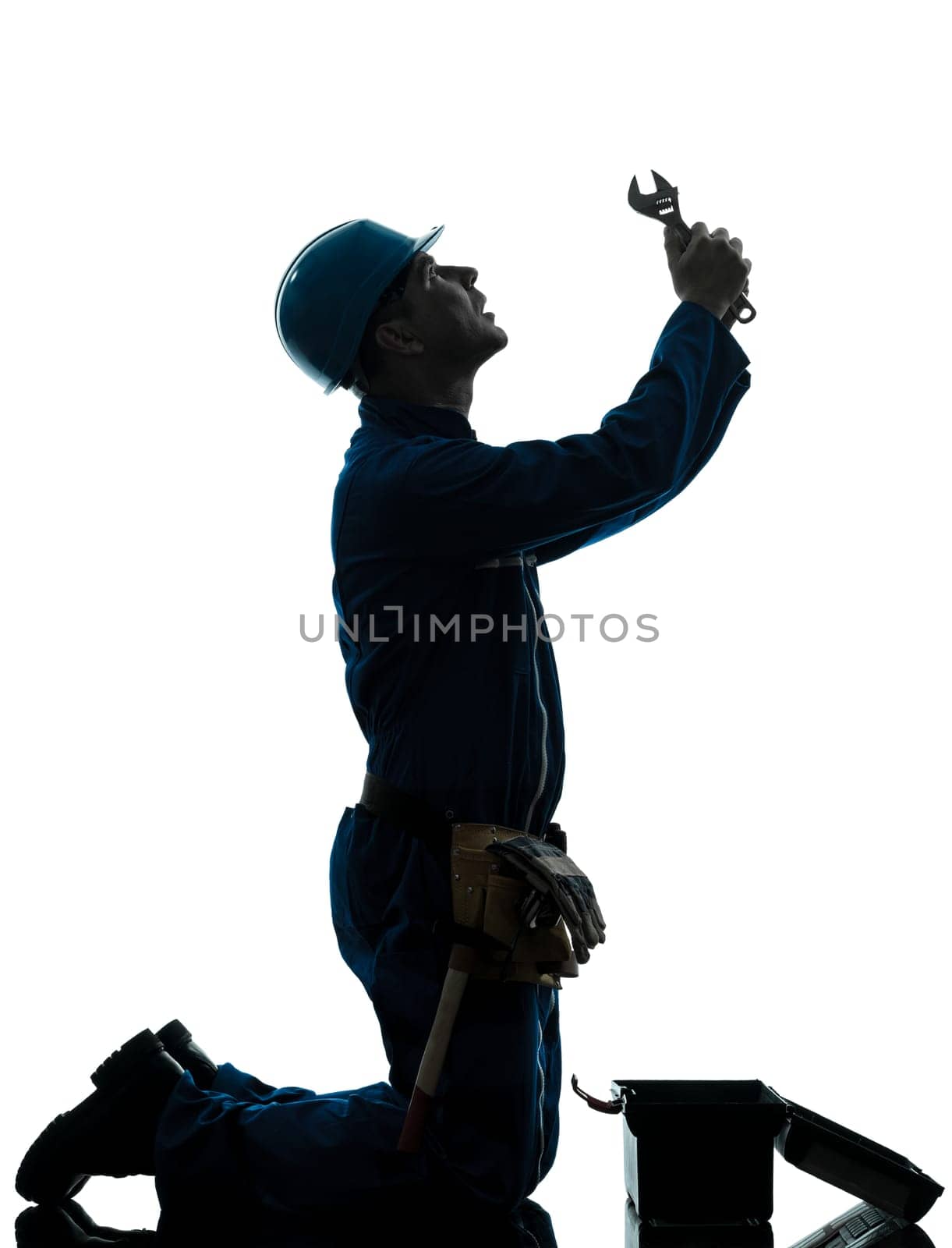 one caucasian repairman worker despair praying silhouette in studio on white background